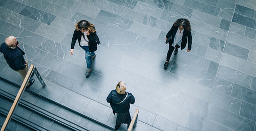 Corporate executives walking across office lobby