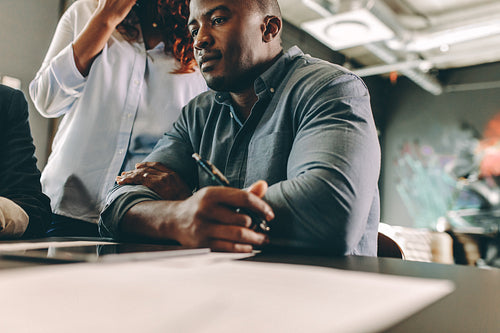 Man in a meeting with colleagues in conference room