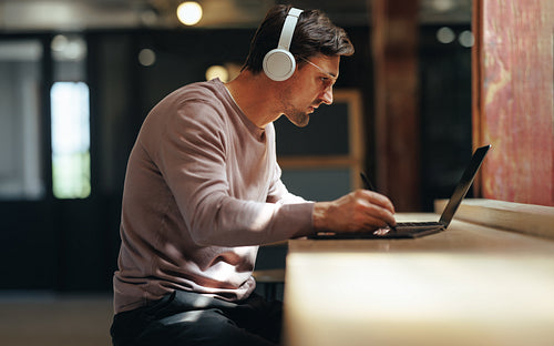 Freelance web designer working with a graphics tablet and a laptop