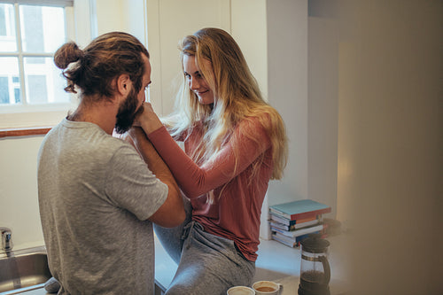 Man kissing the hands of his wife at home