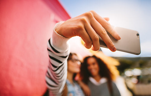 Girl travelers taking a selfie using mobile phone