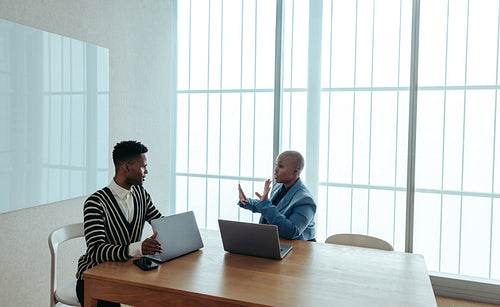 Business professionals engaged in a strategy session discussing management solutions