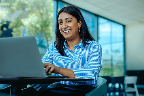 Indian businesswoman engaging in a virtual meeting at office