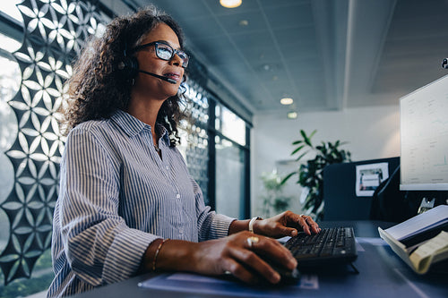 Customer service agent working at  her desk