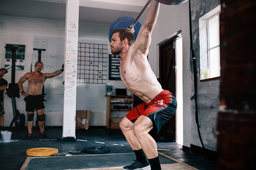 Bodybuilder doing cross training with barbell