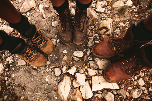Hikers on rocky path wearing trekking boots