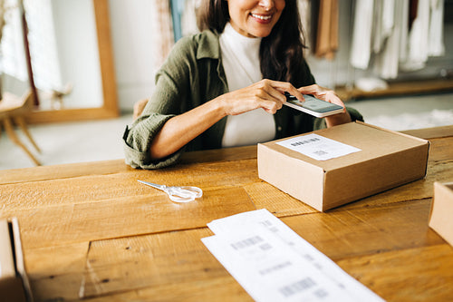 Online store owner scanning a Qr code with a mobile scanner app