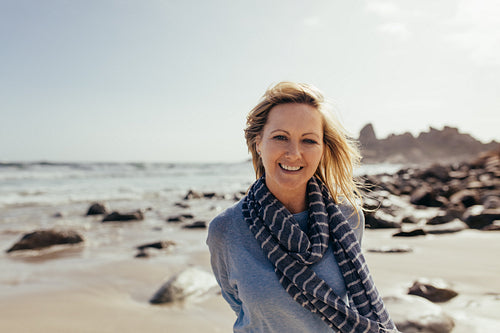Beautiful senior woman smiling on the beach