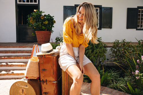 Woman leaving a hotel after a fun vacation