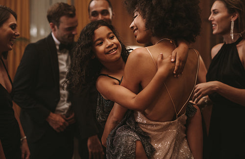 Woman dancing with her cute girl at party