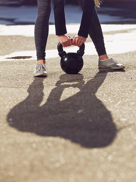 Kettlebell Being Lifted by Fitness Woman