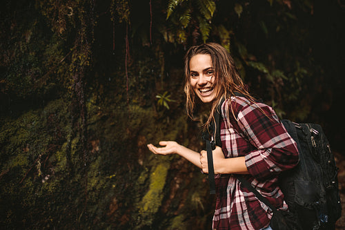 Cheerful woman enjoying a hike in rain forest