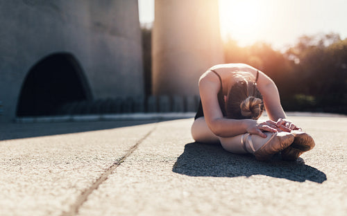 Female ballet dancer warming up before the practice