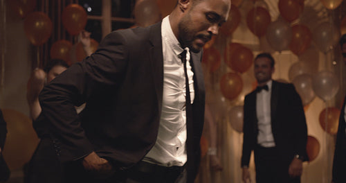 Man dancing at gala night with his friends