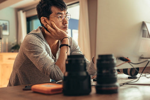 Photographer thinking while editing pictures