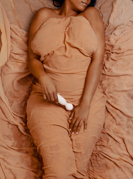 Intimate bedroom fantasy: Sensual woman enjoying pleasure with a stimulator