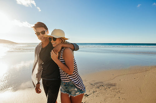 Happy couple walking on beach