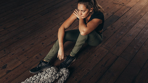 Woman taking rest after working out at fitness studio