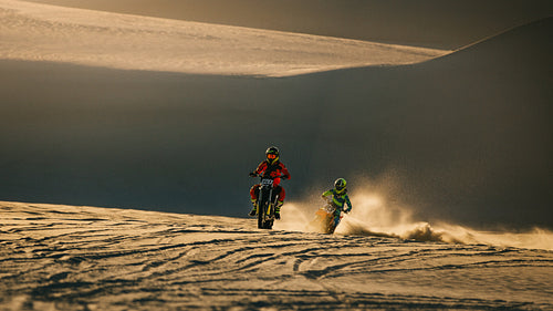 Motocross racers on sand dunes