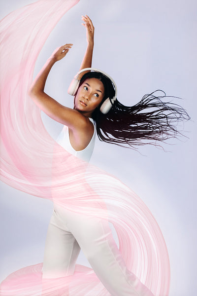 Woman in her 20’s dancing to music with headphones on