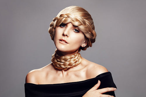 Beautiful young woman with creative braid hairdo