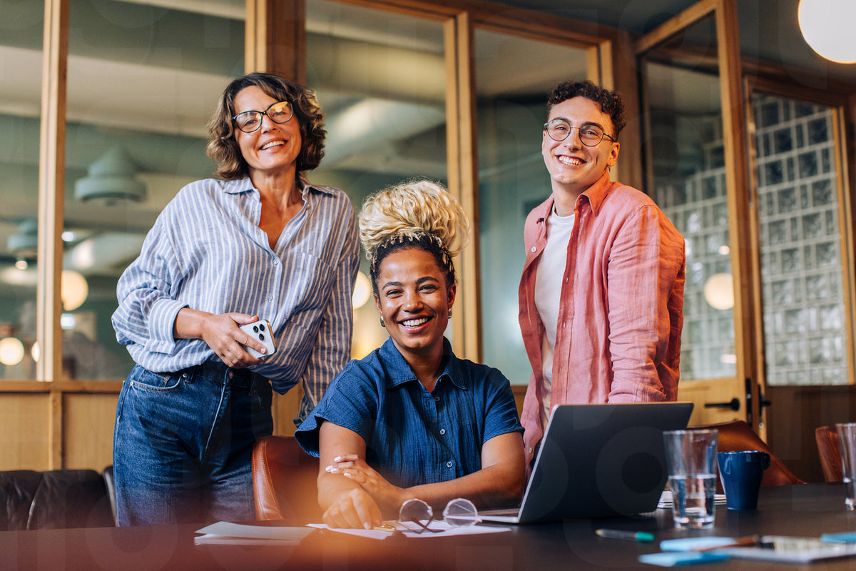 3friends Work Smiling group of three friends together in a comfortable office space ...