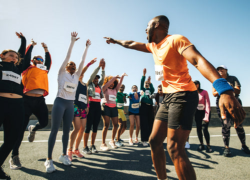 Dynamic running club with coach energizing the group