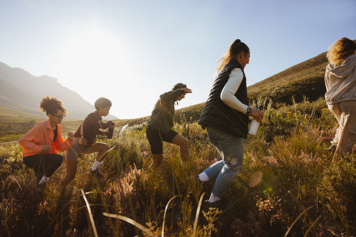 Group hiking through a sunny field