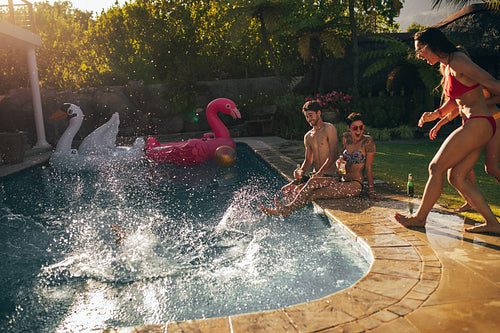 Group of young people enjoying at poolside party