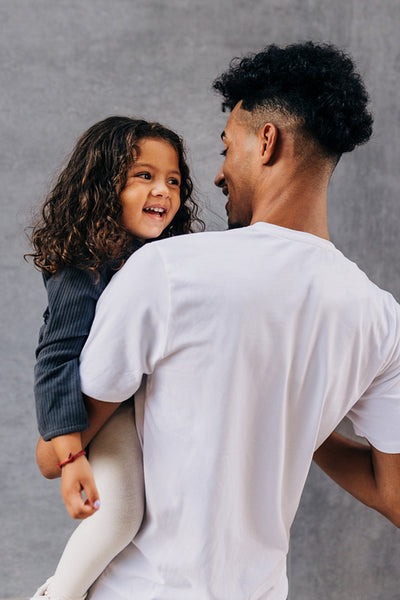 Dad celebrating father's day with his adorable daughter in a studio
