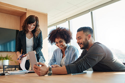 Business people with digital tablet sitting in modern office