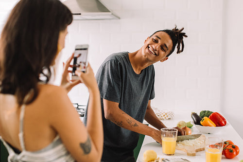 Smiling couple recording content for their cooking blog