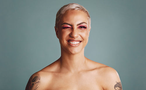 Close up portrait of blonde tattooed woman