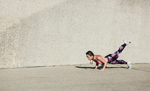 Young muscular woman doing core exercise