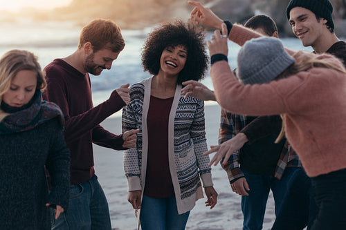 Friends partying on the beach and dancing