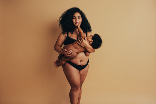 Strong woman with postnatal body