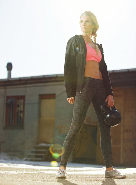 Attractive Crossfit Woman Holding a Kettlebell