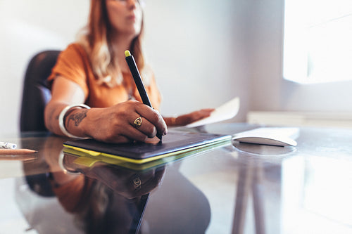 Close up of an illustrator making a drawing on computer