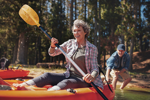 Mature couple enjoying a day at the lake with kayaking