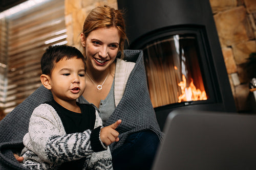 Mother and son with laptop at home