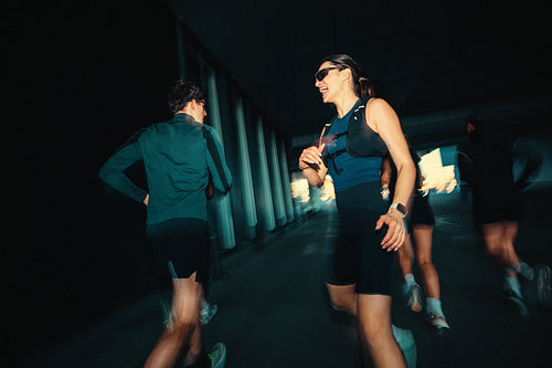 Under an urban bridge, running keeps the young adult group training together