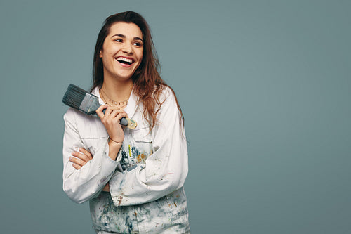 Happy young painter laughing in a studio