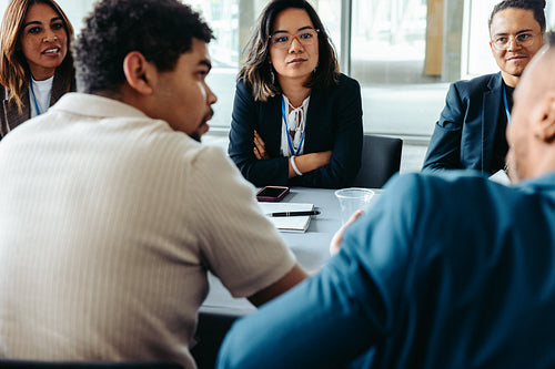 Diverse group of colleagues having a discussion in modern office environment