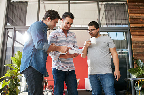 Businesspeople discussing paperwork in office