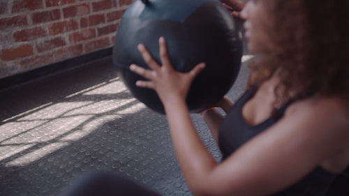 Women working out at gym with fitness ball