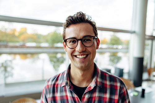 Portrait of a happy young businessman in office