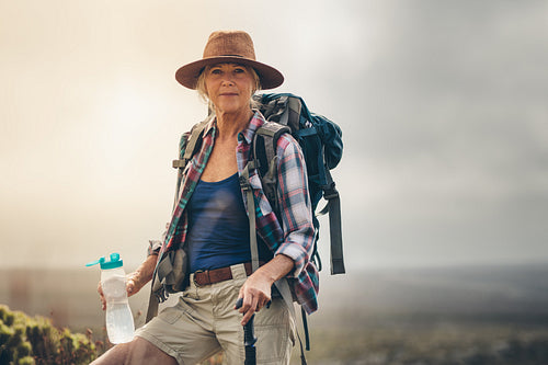 Woman hiker drinking water during her trek