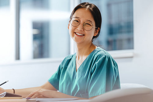 Portrait of a happy Asian nursing student studying for an exam