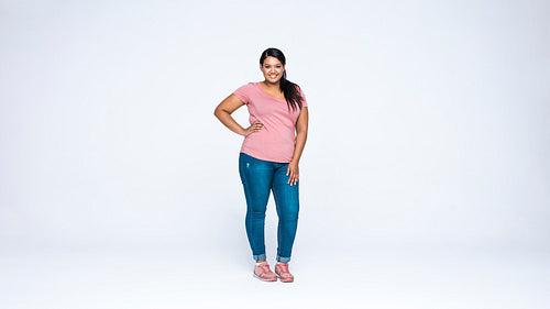 Young woman standing against white background