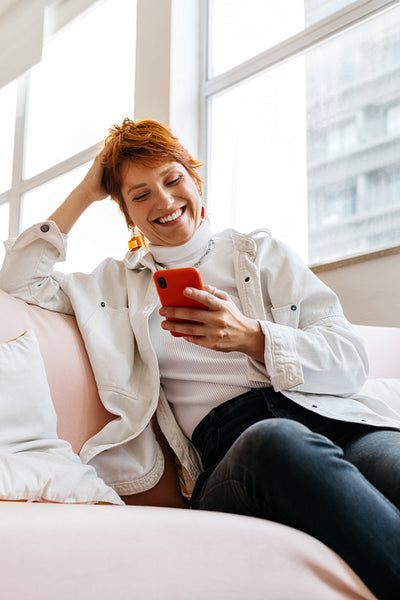 Freelancer using smartphone in a bright co-working space